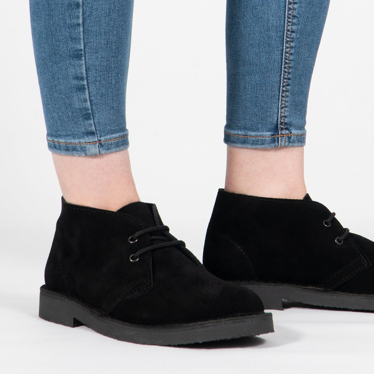 Roamers ORIGINAL Unisex Desert Boots in Black, worn with blue jeans, pair shown from the front