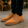 Popps JONAS Mens Suede Desert Shoes in Cognac, worn with black jeans at a cafe terrace