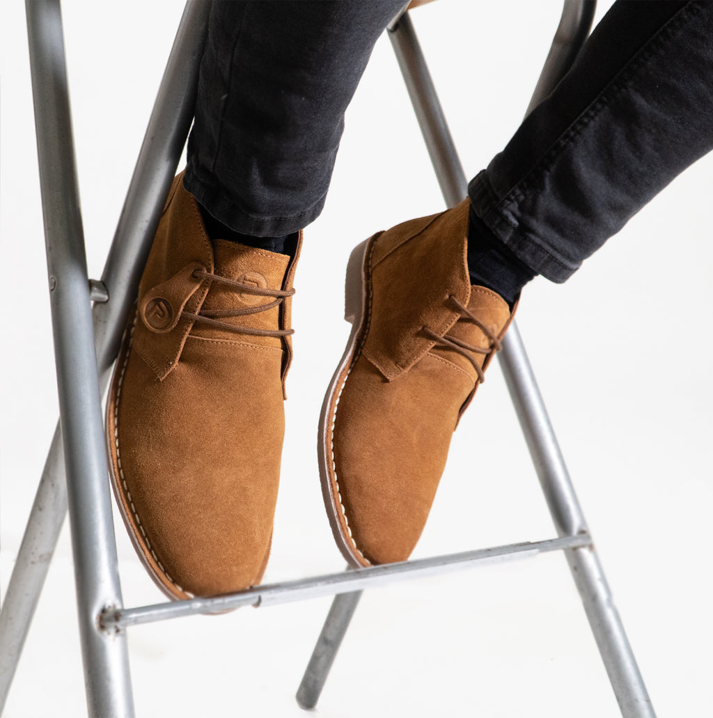 Popps VESPA Unisex Desert Boots in Cognac, worn with dark jeans, sitting on ladder steps